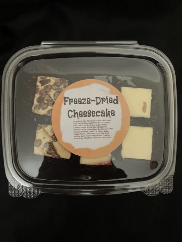 Freeze-dried cheesecake squares in a container.