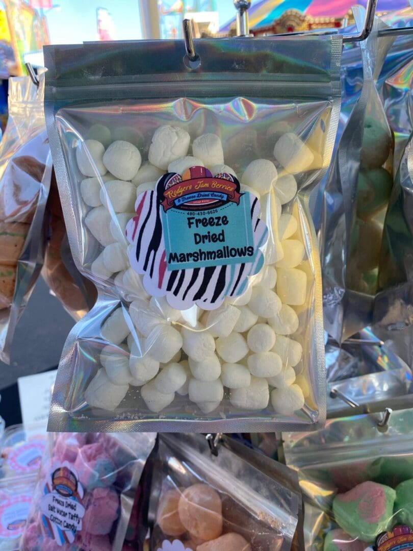 A bag of white marshmallows on top of a table.