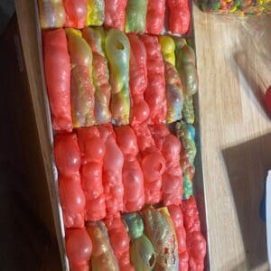 A tray of tomatoes on top of a table.