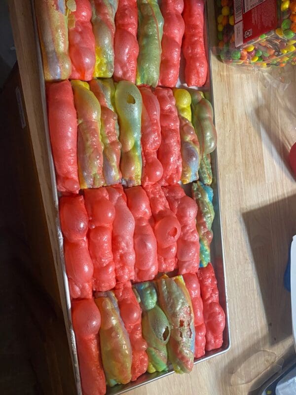 A tray of tomatoes on top of a table.