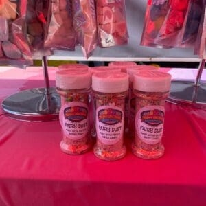 A table with several jars of spices on it.