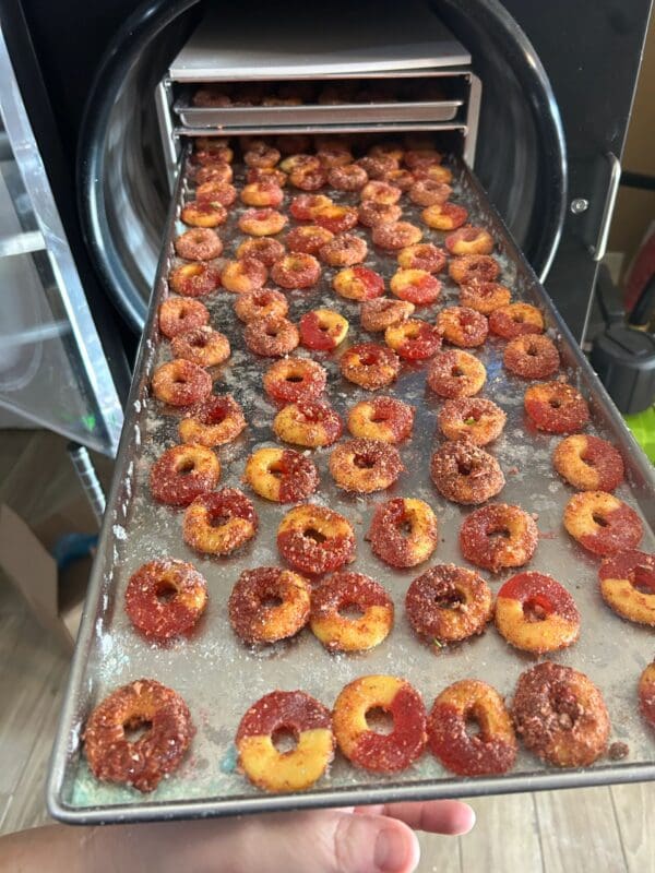 A conveyor belt with many different types of donuts.