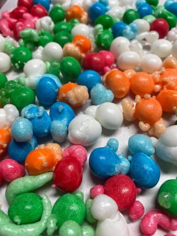 A close up of many different colored candies