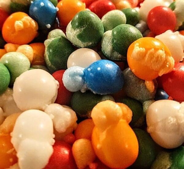 A pile of different colored candy is shown.