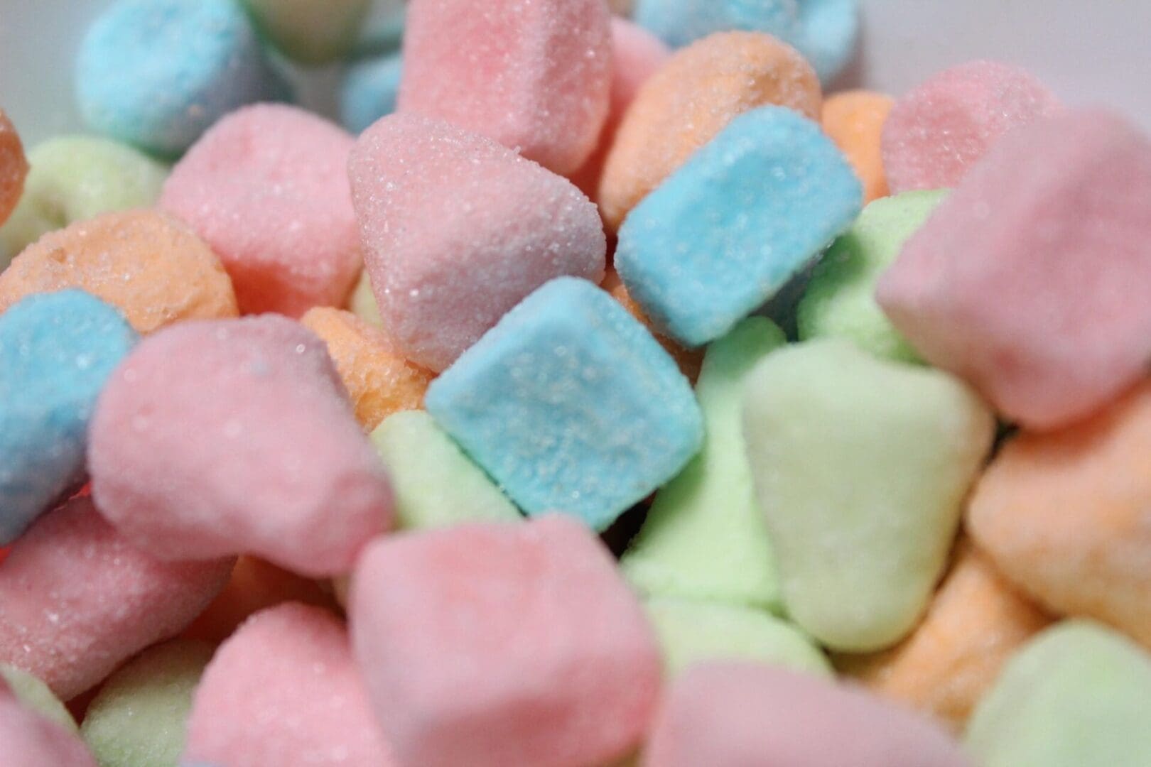 A close up of some marshmallows in different colors