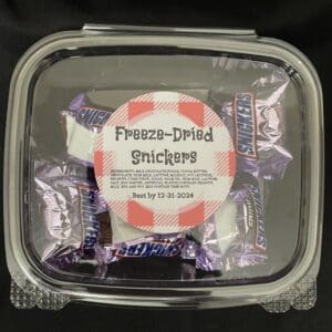 Freeze-dried Snickers candy in a container.