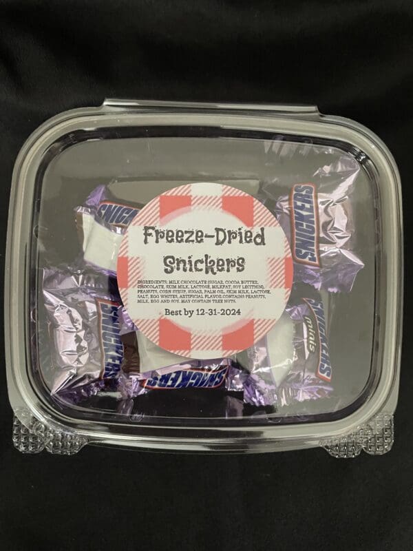 Freeze-dried Snickers candy in a container.